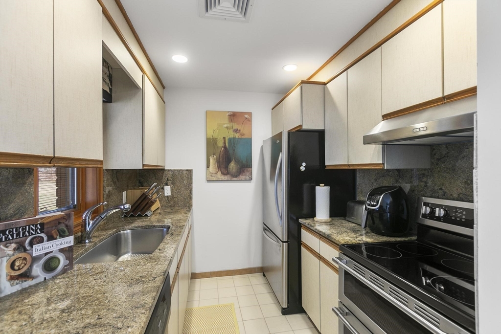 5 Crestwood Road North Reading, MA 01864 - Photo 29 of 40 a kitchen with stainless steel appliances granite countertop a sink stove and refrigerator