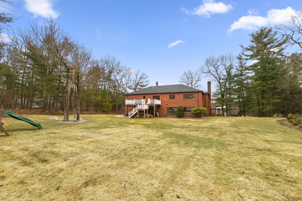 5 Crestwood Road North Reading, MA 01864 - Photo 37 of 40 a view of a swimming pool with a house in the background