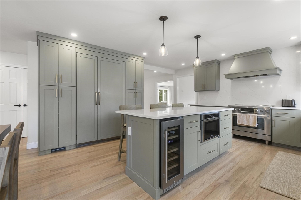 5 Crestwood Road North Reading, MA 01864 - Photo 8 of 40 a kitchen with stainless steel appliances a stove a sink a refrigerator and a wooden floor