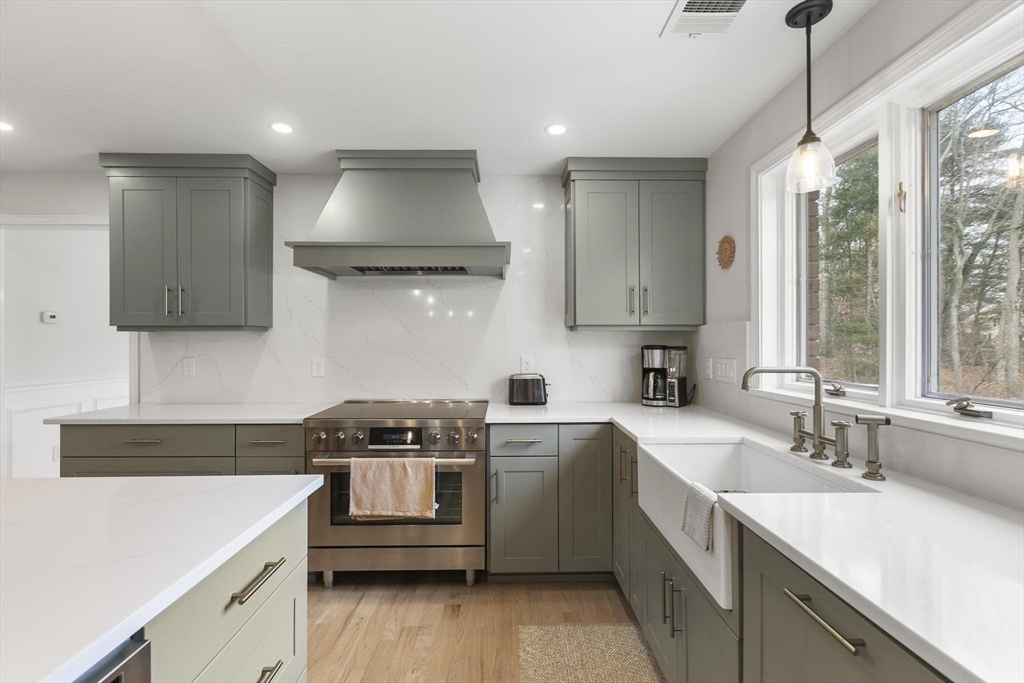 5 Crestwood Road North Reading, MA 01864 - Photo 9 of 40 a kitchen that has a sink a stove and cabinets