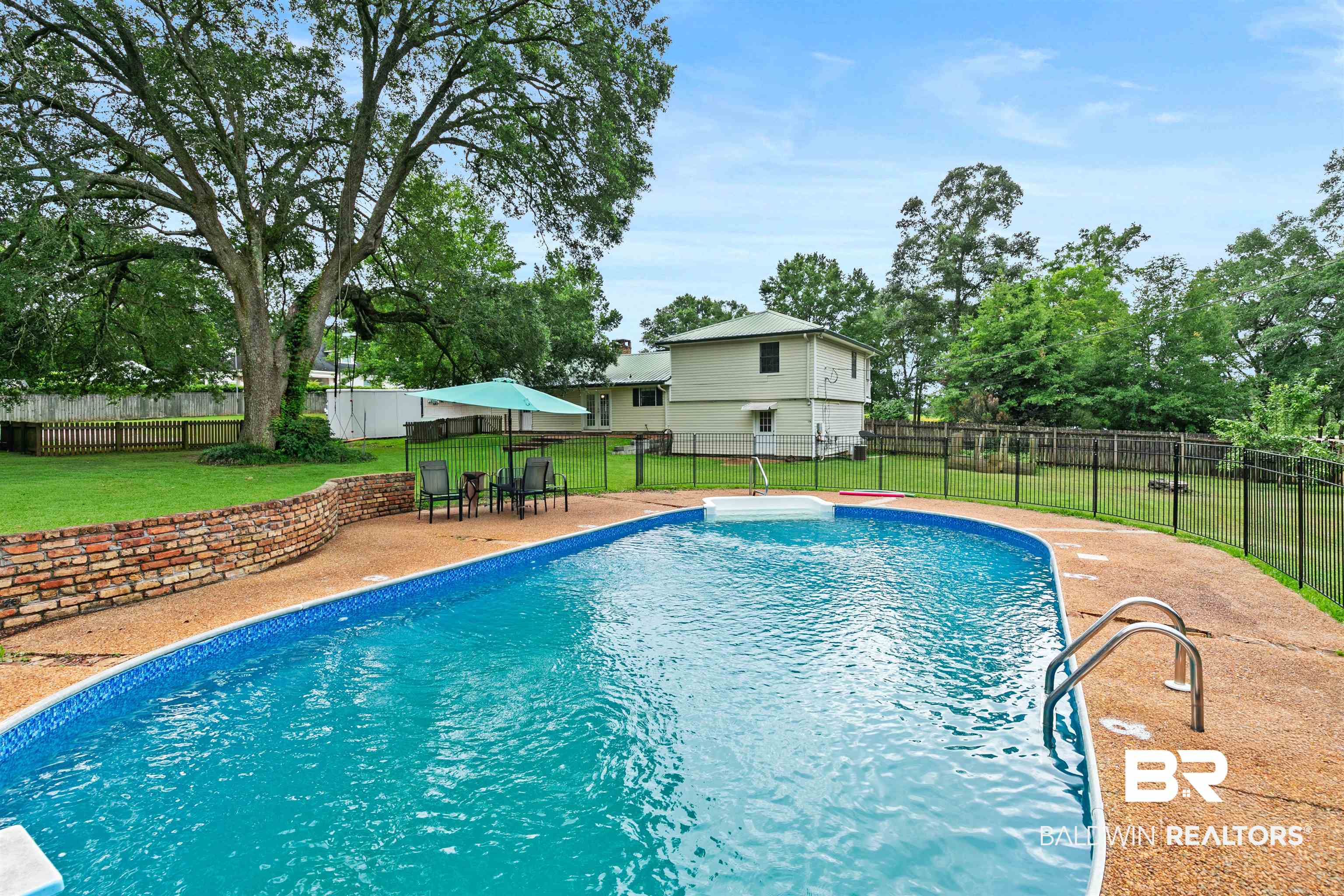 10420 Johnson Road South Mobile, AL 36695 - Photo 61 of 75 Curved inground pool with concrete surround and metal access rails