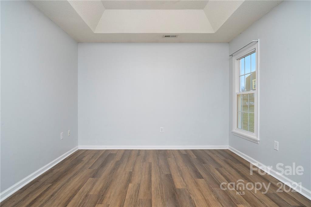 2432 River Chase Drive Monroe, NC 28110 - Photo 10 of 18 a view of an empty room with wooden floor and a window