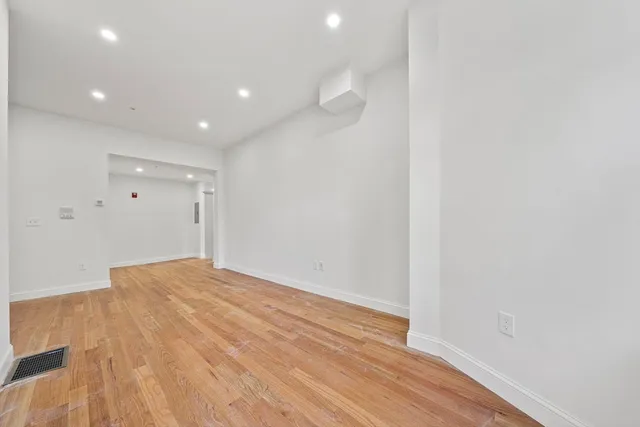 a view of hallway with wooden floor
