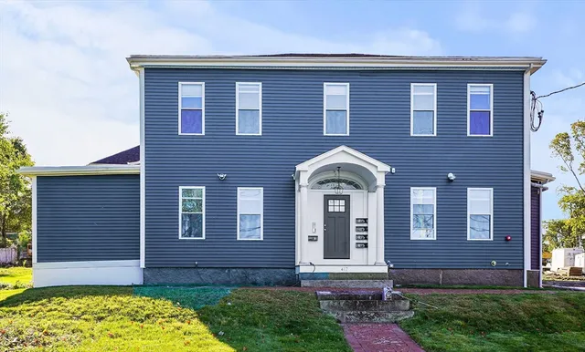 a front view of a house with garden