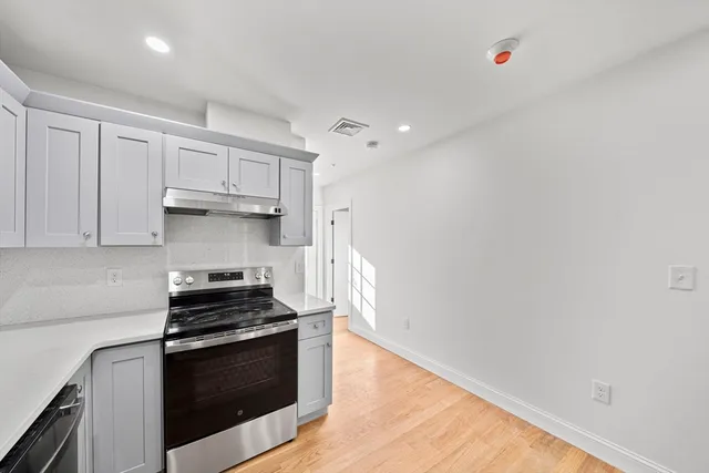 a kitchen with stainless steel appliances a stove and a refrigerator