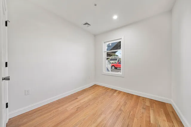 a room with a wooden floor and white walls