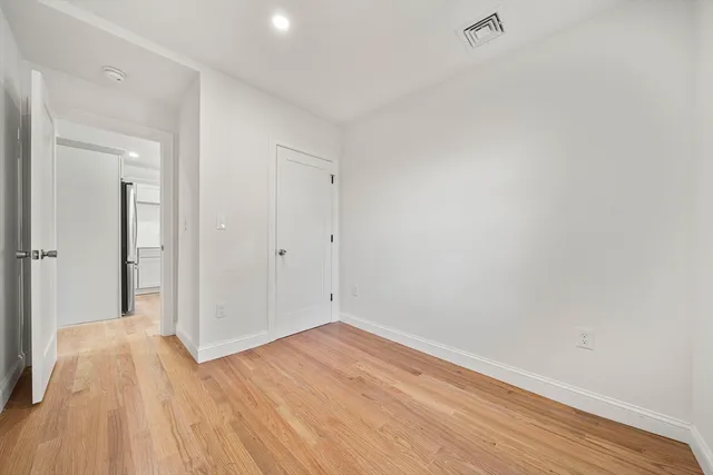 a view of a room with wooden floor