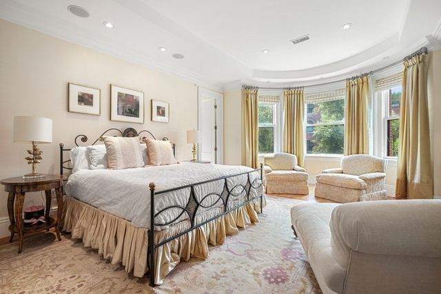 a spacious bedroom with a bed and a couch