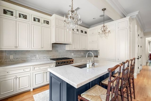 a kitchen with cabinets appliances and a center island