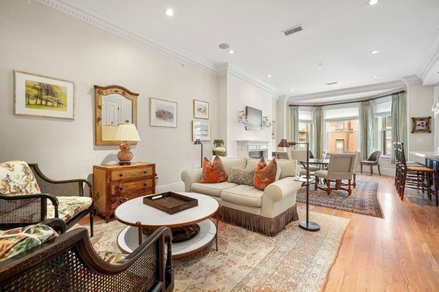a living room with furniture a rug and a table