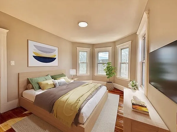 a bedroom with a bed and a flat screen tv