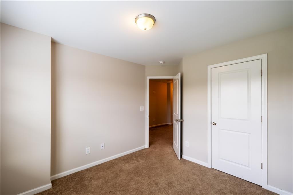 221 Winterset Circle Hoschton, GA 30548 - Photo 19 of 23 an empty room with closet and mirror