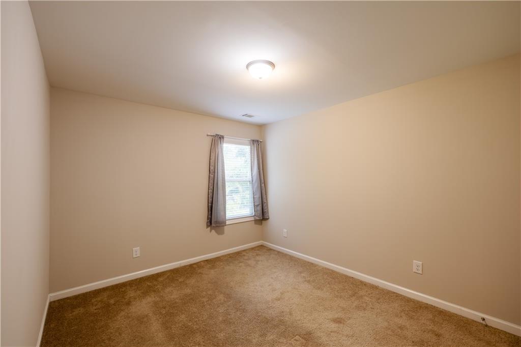 221 Winterset Circle Hoschton, GA 30548 - Photo 22 of 23 an empty room with windows