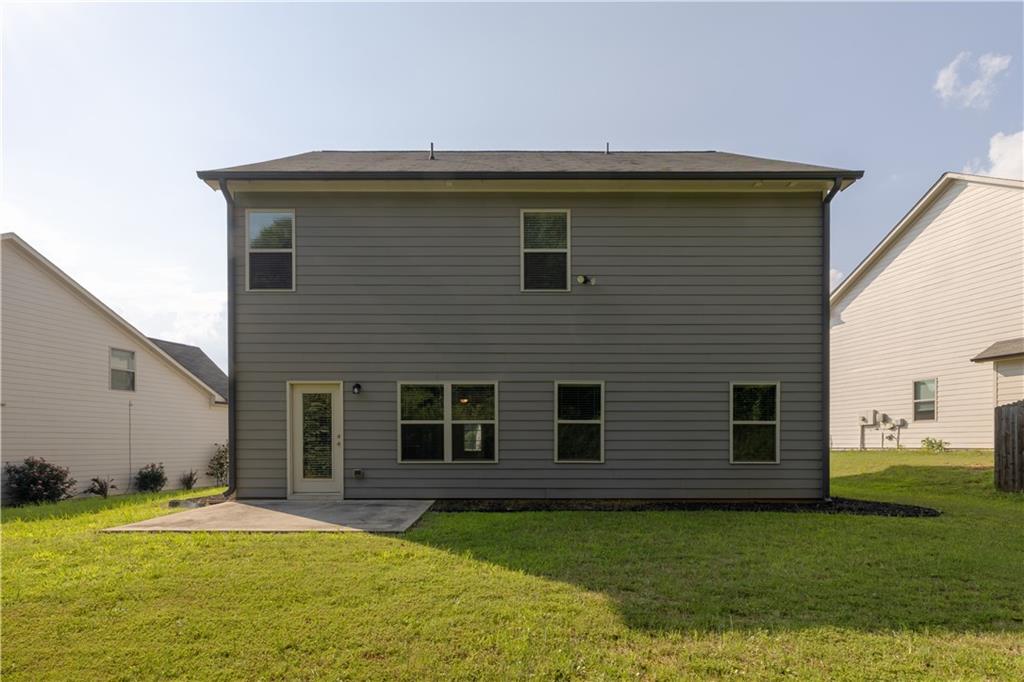 221 Winterset Circle Hoschton, GA 30548 - Photo 3 of 23 a front view of a house with a garden