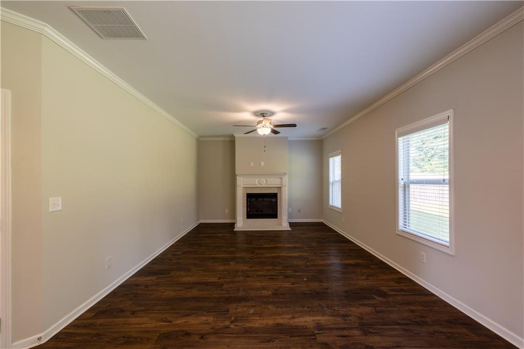 221 Winterset Circle Hoschton, GA 30548 - Photo 7 of 23 wooden floor in an empty room with a window