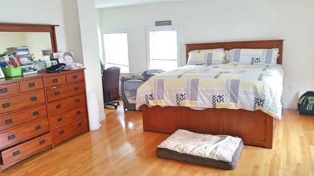 a bedroom with a bed and a dresser