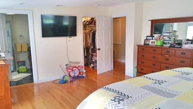 a bedroom with a bed and a flat screen tv