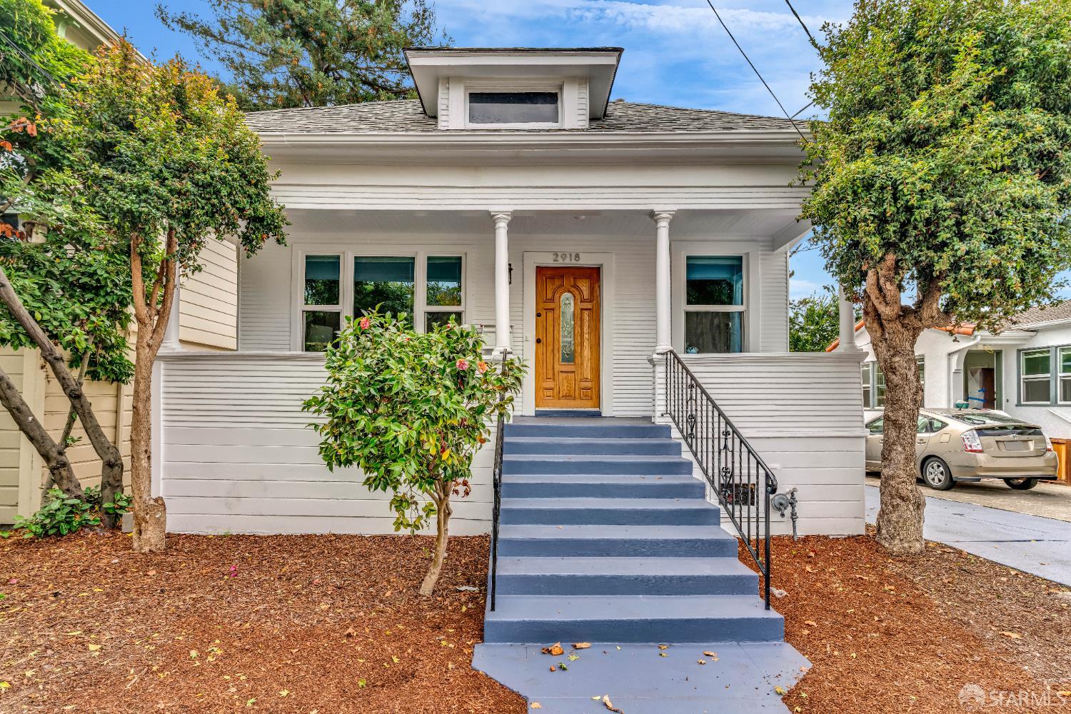 2918 Newbury Street Berkeley, CA 94703 - Photo 1 of 42 a view of a house with a large windows and flower plants