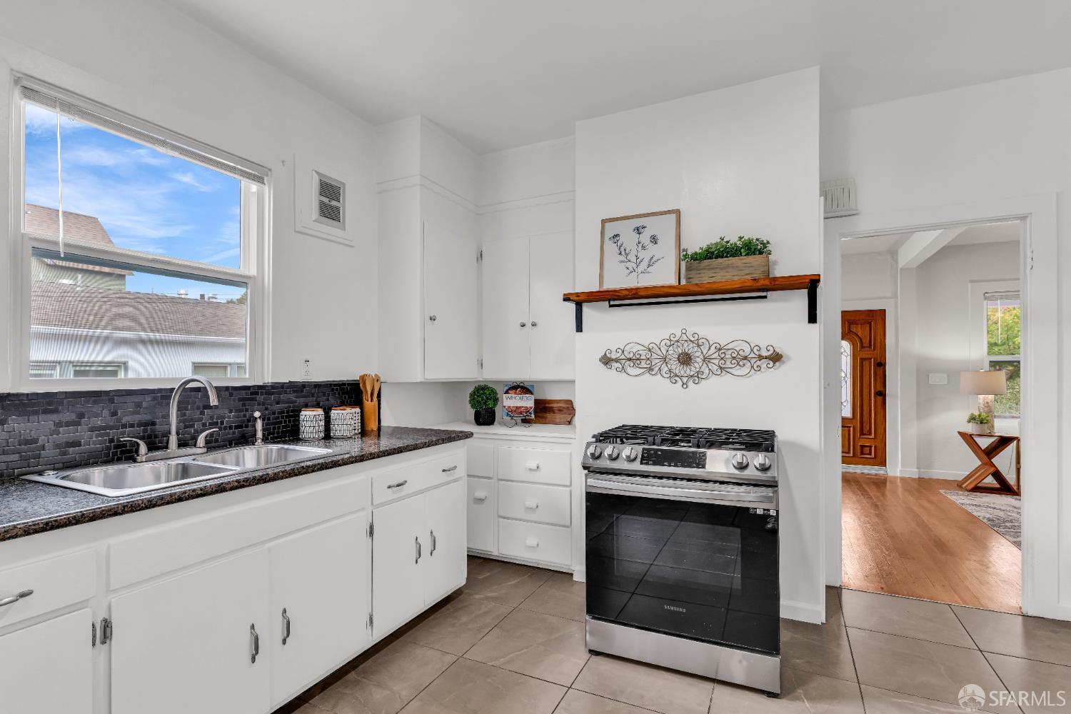 2918 Newbury Street Berkeley, CA 94703 - Photo 19 of 42 a kitchen with stainless steel appliances granite countertop white cabinets and a stove