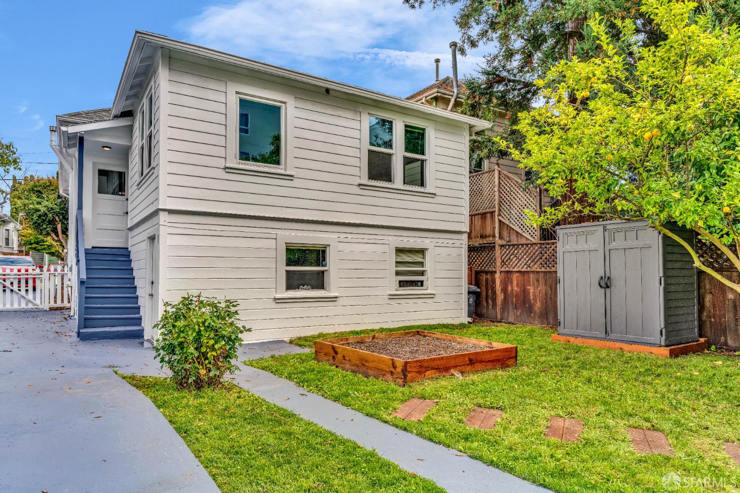 2918 Newbury Street Berkeley, CA 94703 - Photo 40 of 42 a view of a house with a small yard and a large tree