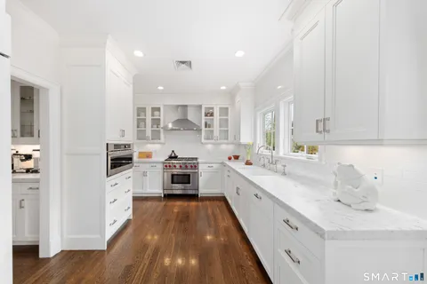 a kitchen with stainless steel appliances a sink stove and cabinets