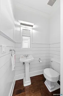 a bathroom with a sink toilet and mirror