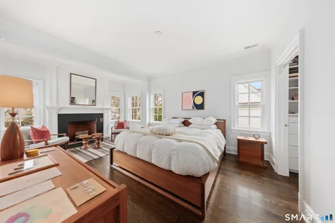 a bedroom with a bed and a fireplace