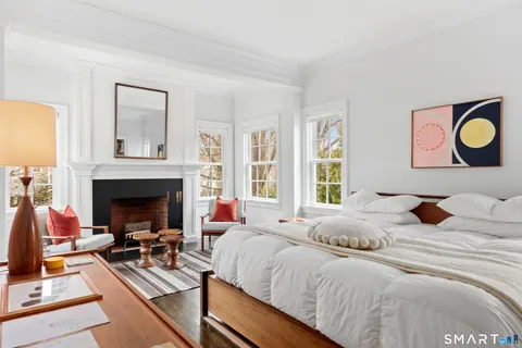 a bedroom with a bed and a fireplace