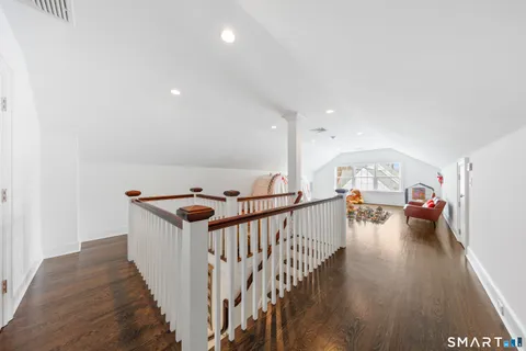 a view of hallway with wooden floor