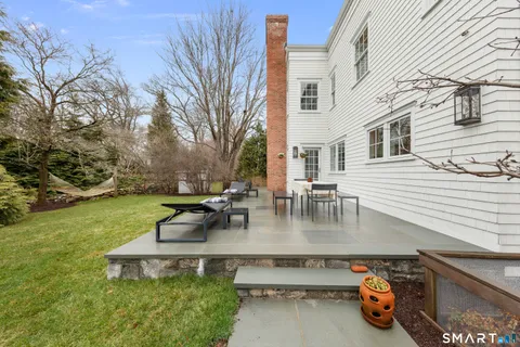 a view of a backyard with sitting area