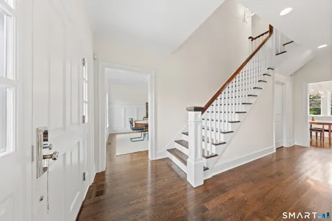 a view of entryway with stairs and wooden floor