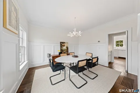 a view of a dining room with furniture and wooden floor