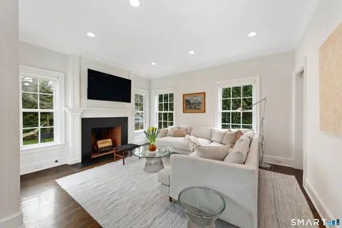 a living room with furniture a flat screen tv and a fireplace