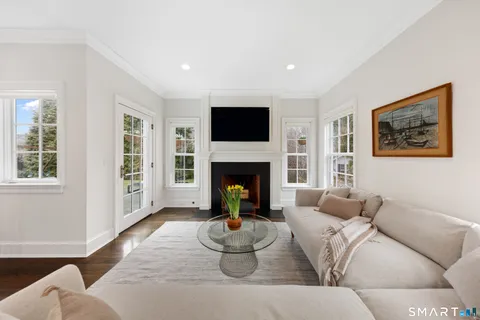 a living room with furniture large window and a fireplace