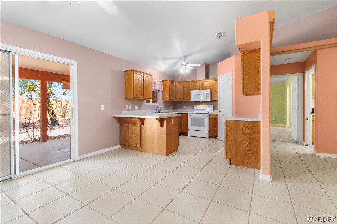 2158 Ranch Road Kingman, AZ 86401 - Photo 9 of 48 a kitchen with stainless steel appliances granite countertop a refrigerator and a sink