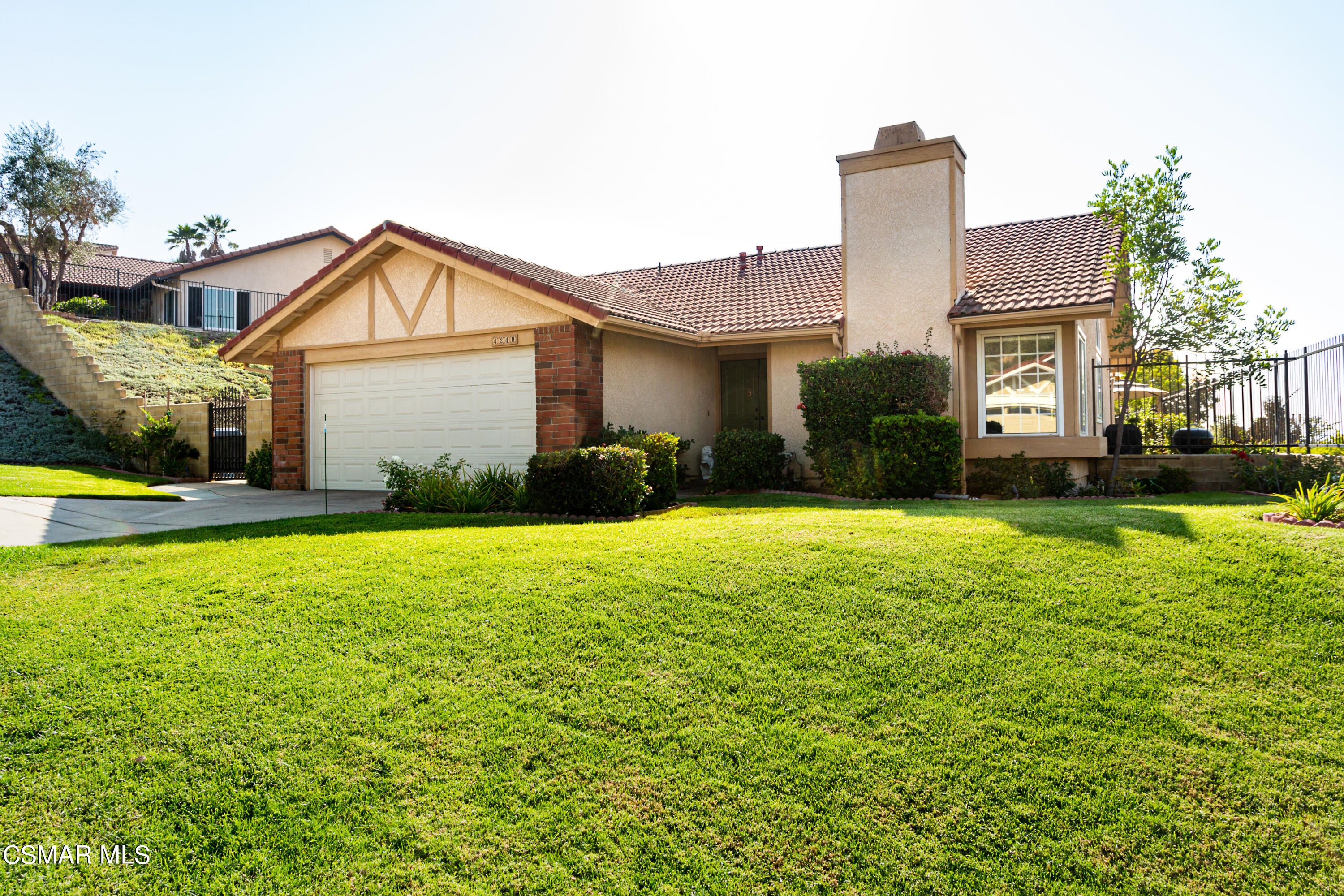 4249 Laurelhurst Road Moorpark, CA 93021 - Photo 1 of 30 a front view of a house with a yard and potted plants