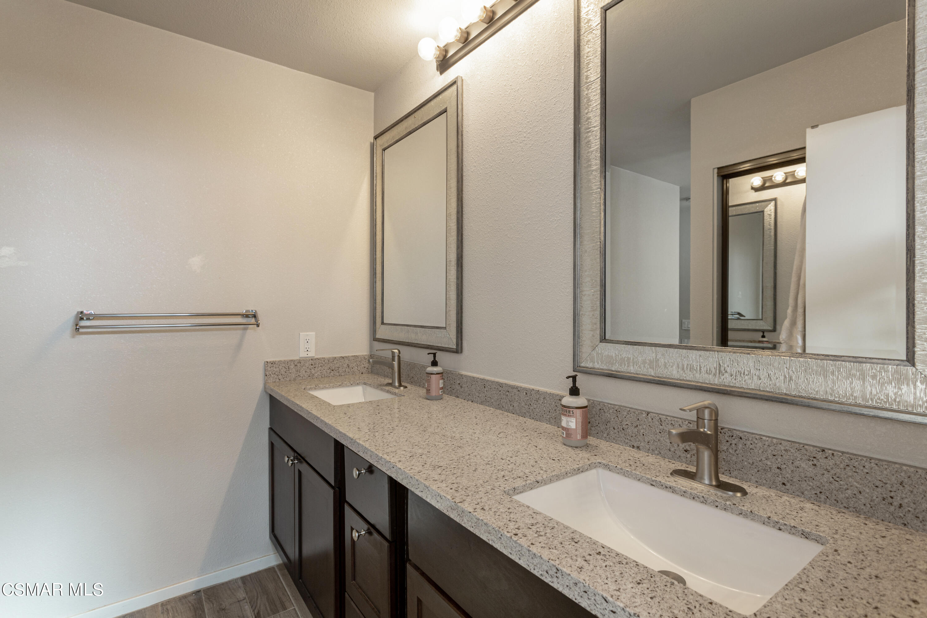 4249 Laurelhurst Road Moorpark, CA 93021 - Photo 17 of 30 a bathroom with a granite countertop sink and a mirror