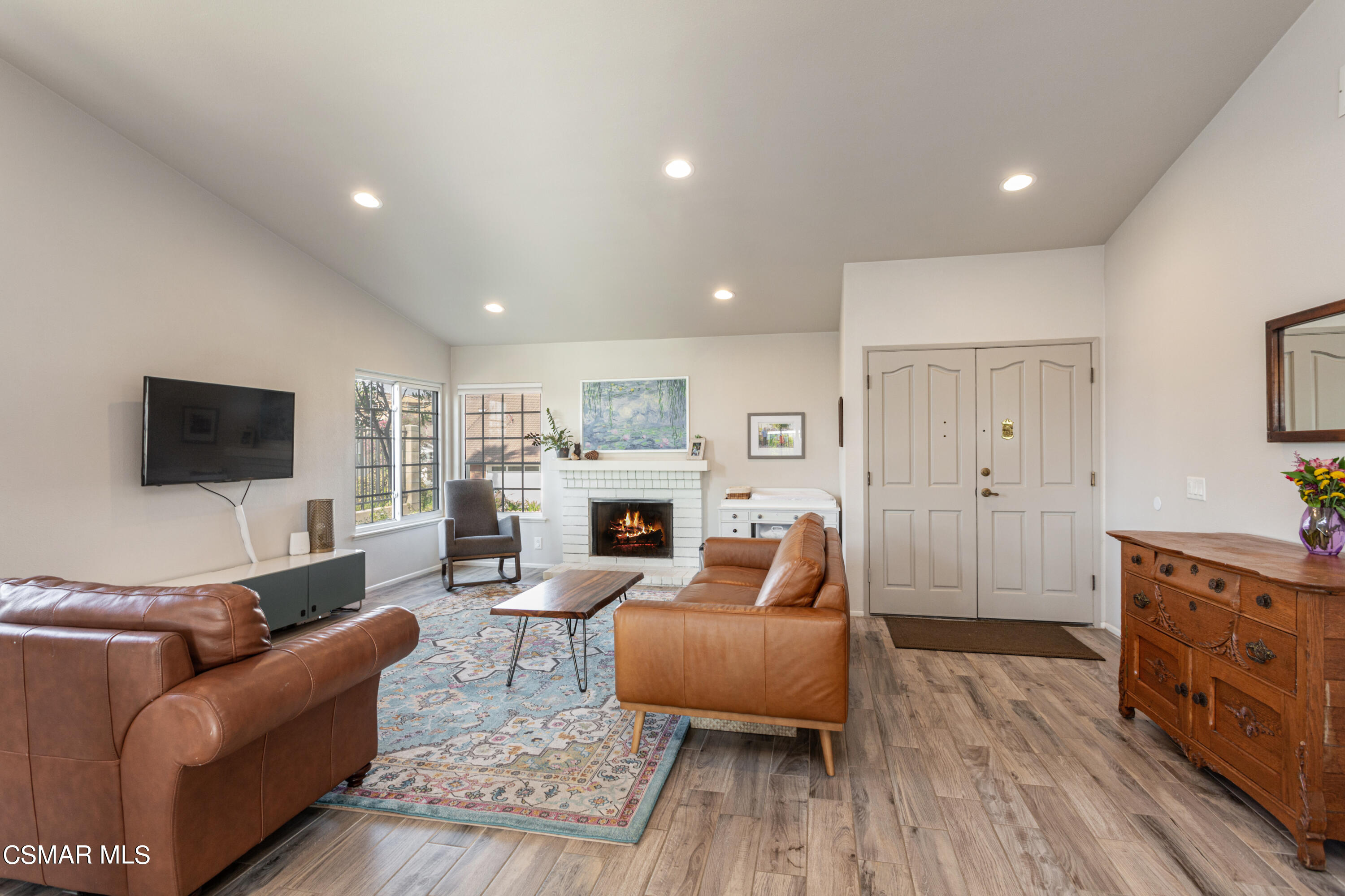 4249 Laurelhurst Road Moorpark, CA 93021 - Photo 7 of 30 a living room with furniture a flat screen tv and a fireplace