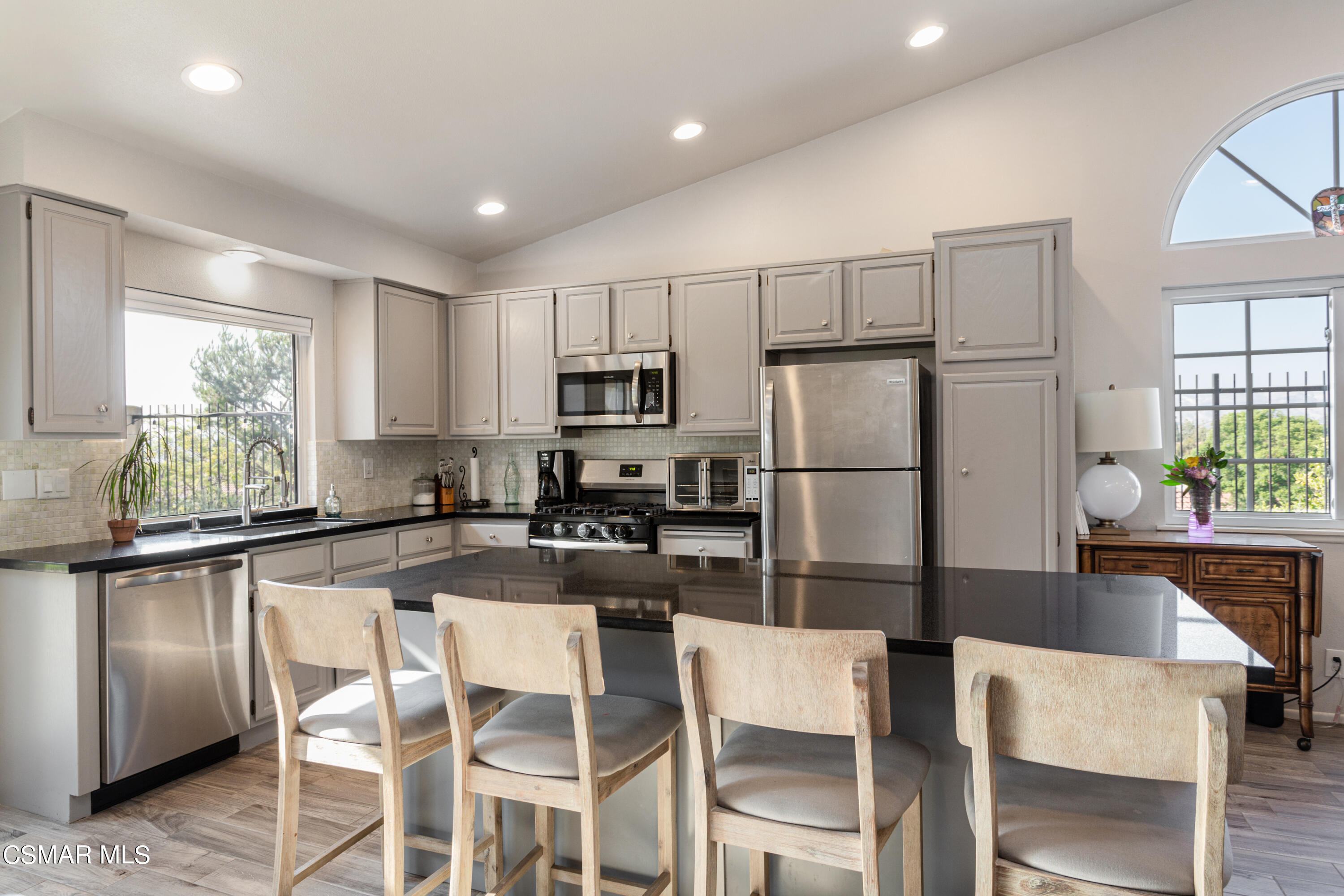 4249 Laurelhurst Road Moorpark, CA 93021 - Photo 10 of 30 a kitchen with refrigerator cabinets dining table and chairs