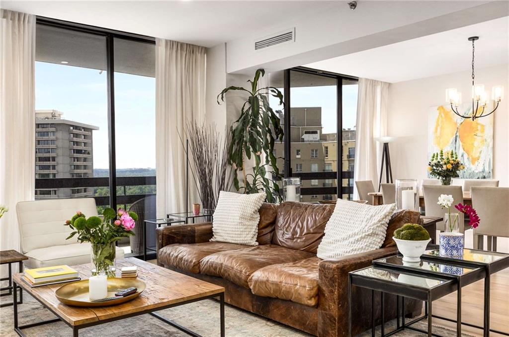 2660 Peachtree Road Northwest, Unit 18H Atlanta, GA 30305 - Photo 11 of 61 a living room with furniture and a large window