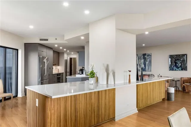 a large kitchen with lots of counter space and stainless steel appliances