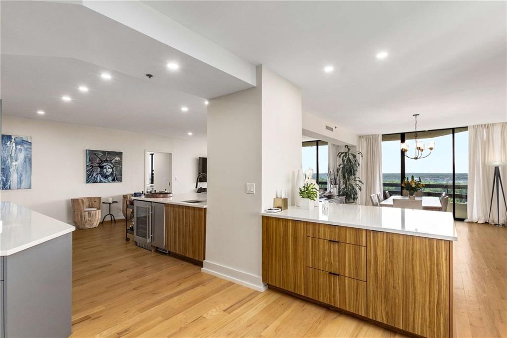 2660 Peachtree Road Northwest, Unit 18H Atlanta, GA 30305 - Photo 16 of 61 a large kitchen with lots of counter space and stainless steel appliances