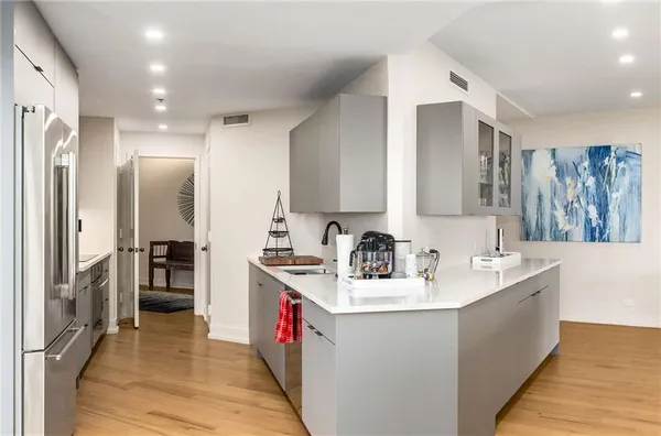 a kitchen with a sink a stove cabinets and a counter top space