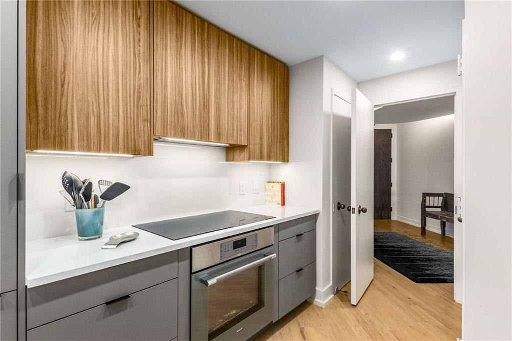 2660 Peachtree Road Northwest, Unit 18H Atlanta, GA 30305 - Photo 18 of 61 a kitchen with a sink and cabinets