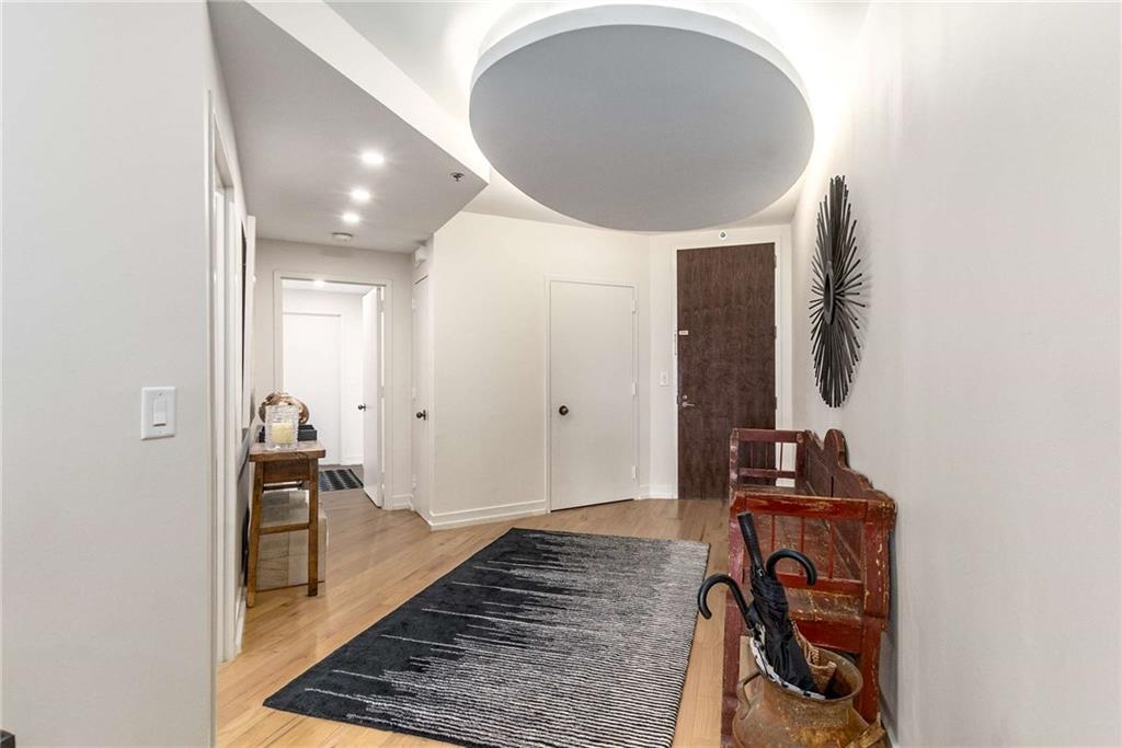 2660 Peachtree Road Northwest, Unit 18H Atlanta, GA 30305 - Photo 2 of 61 a view of a hallway with wooden floor and a bathroom