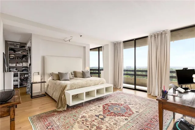 a view of walk in closet with clothes and shoes