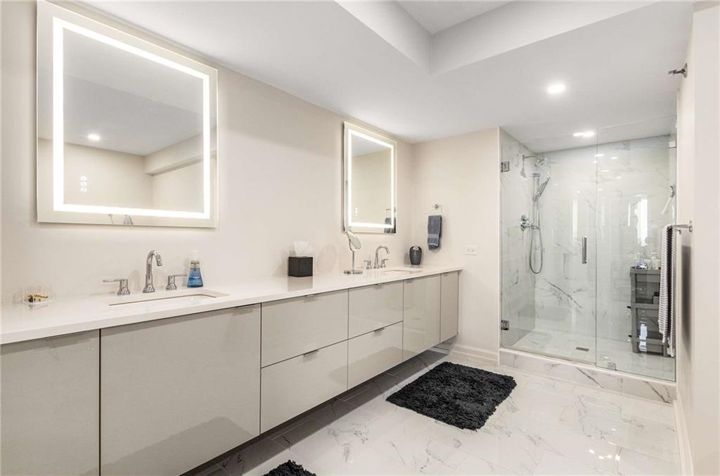 2660 Peachtree Road Northwest, Unit 18H Atlanta, GA 30305 - Photo 26 of 61 a bathroom with a sink and a mirror