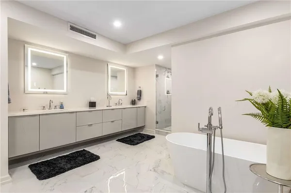 a bathroom with a bathtub and shower