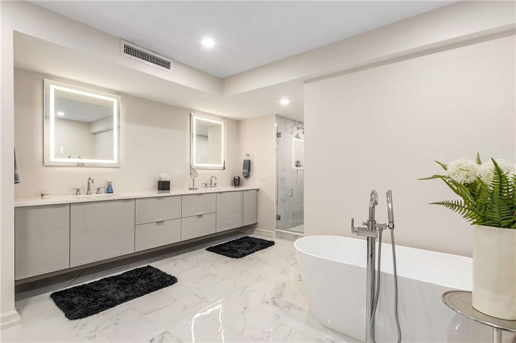 2660 Peachtree Road Northwest, Unit 18H Atlanta, GA 30305 - Photo 27 of 61 a room with a sink and a mirror