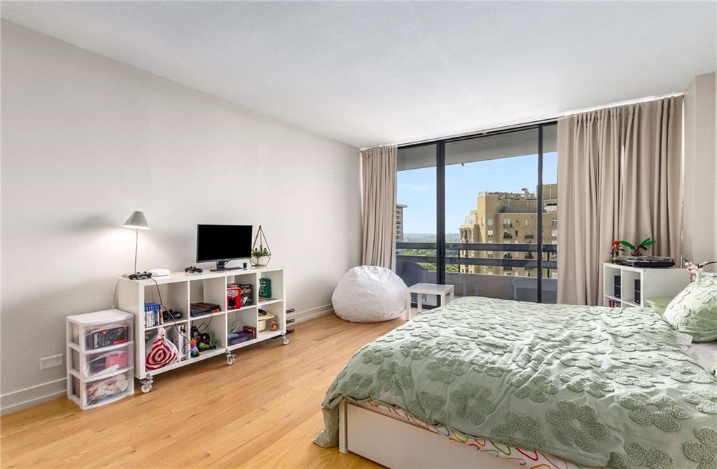 2660 Peachtree Road Northwest, Unit 18H Atlanta, GA 30305 - Photo 28 of 61 a bedroom with a bed and a flat screen tv